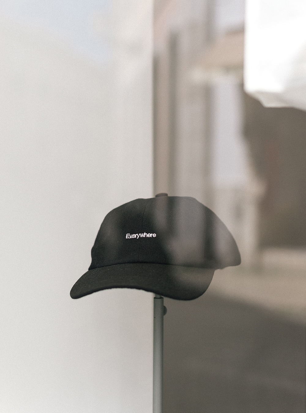 The everywhere cap, in black, in display at the window of wetheknot shop in Lisbon
